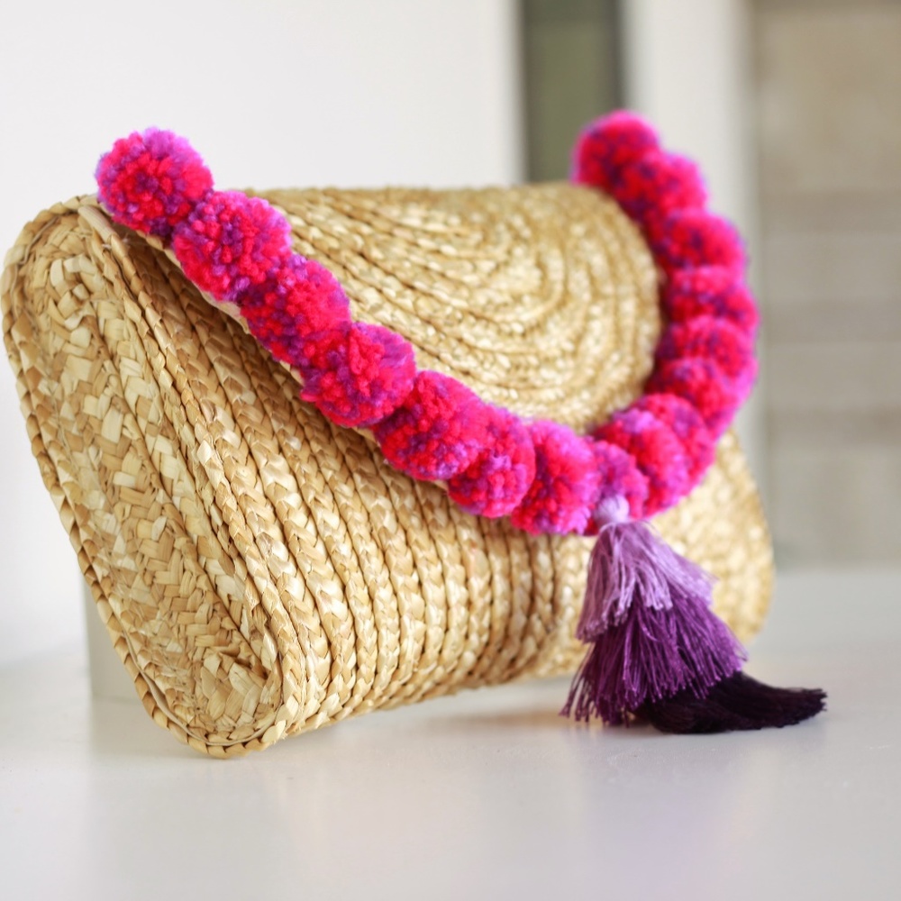 Straw clutch with purple tassel